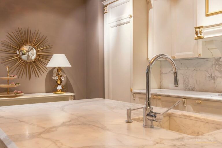 Spotless kitchen sink and faucet on a clean marble counter